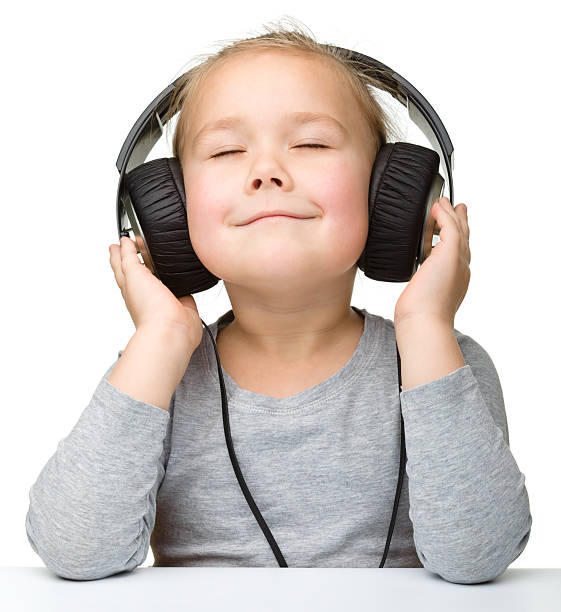 Smiling girl with eyes closed and headphones on stock photo