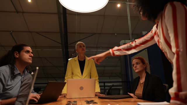 Angry businesswoman talking with coworkers during a meet at office
