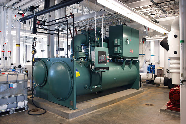 Mechanical room The water chiller in the mechanical room of a large building chiller hvac equipment photos stock pictures, royalty-free photos & images
