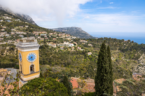 Bell tower of the Notre-Dame-de-l'Assomption church in Eze with the summit of the Tête au Chien in the background