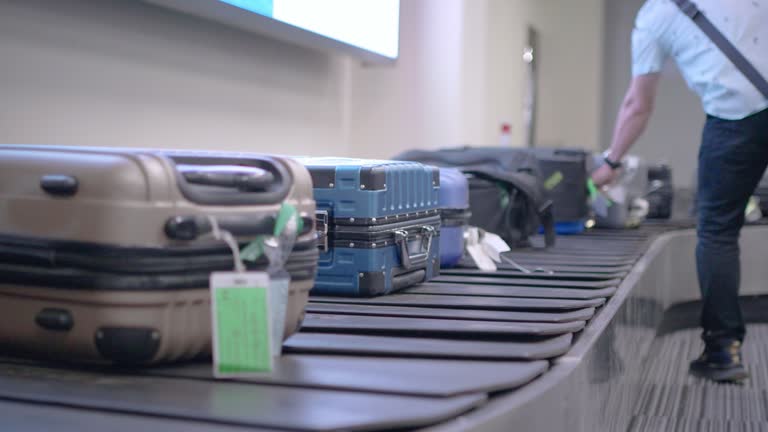 Traveler passenger pieces of luggage moving on the baggage belt at the airport.