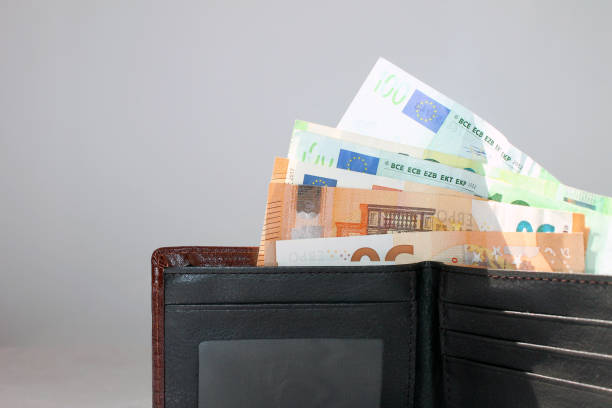 man's wallet full of euro bills