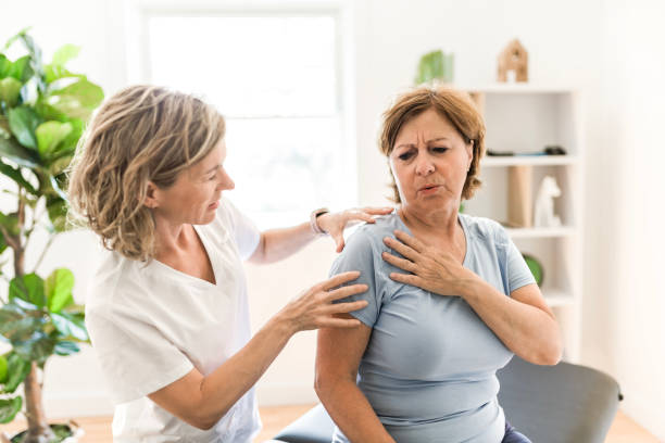 istock Physiotherapist working with elderly patient in clinic 1556301042