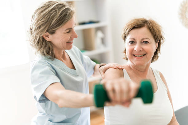 istock Physiotherapist working with elderly patient in clinic 1556302666