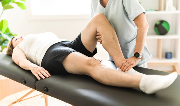 istock Physiotherapist working with elderly patient in clinic 1556303184