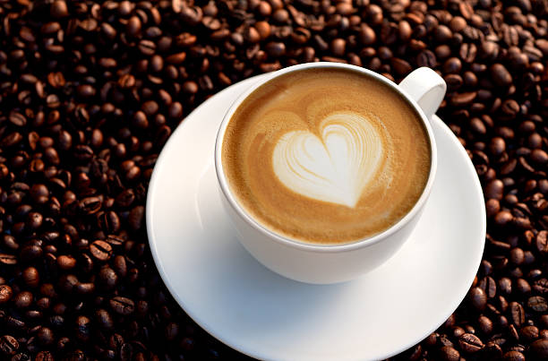 istock Coffee cup with milk heart on coffee beans 155632806