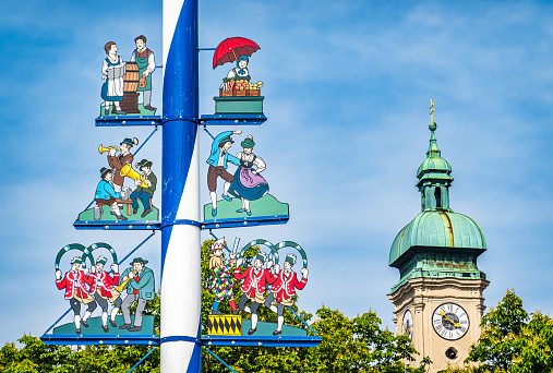 Munich, Germany - May 9: typical bavarian maypole at the viktualienmarkt at the old town of Munich on May 9, 2023