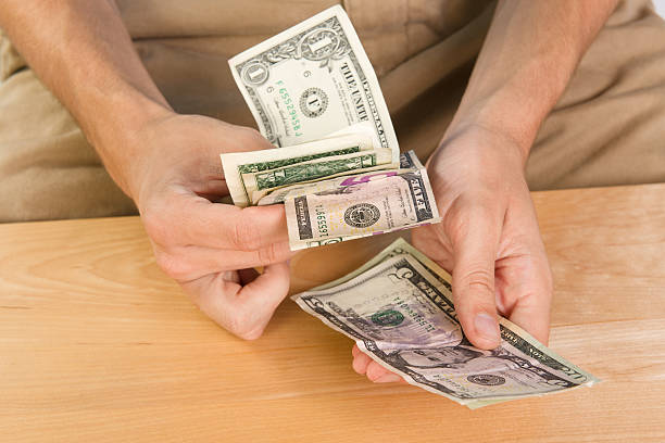 istock Male counting money 155633140