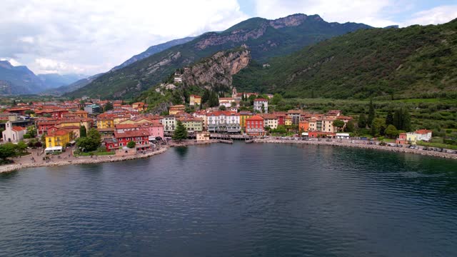 Scenic Garda lake , popular beautiful town and resort Riva del Garda. aerial drone high angle video. Trentino, Lago di Garda, Italy
