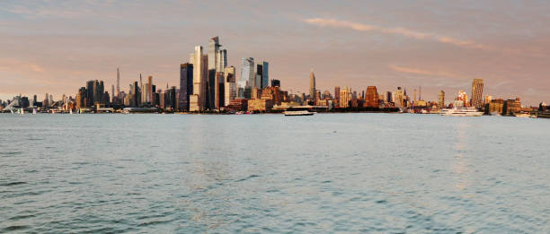 istock Stitched Panorama of Manhattan Skyline at Sunset 1556349970