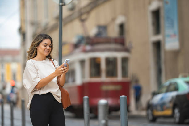 istock Woman waiting for a tram in Lisbon 1556357354