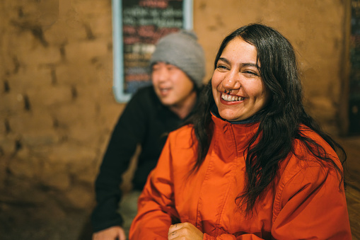 Smiling people at rustic bar in San Pedro de Atacama