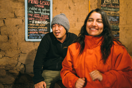 Smiling people at rustic bar in San Pedro de Atacama