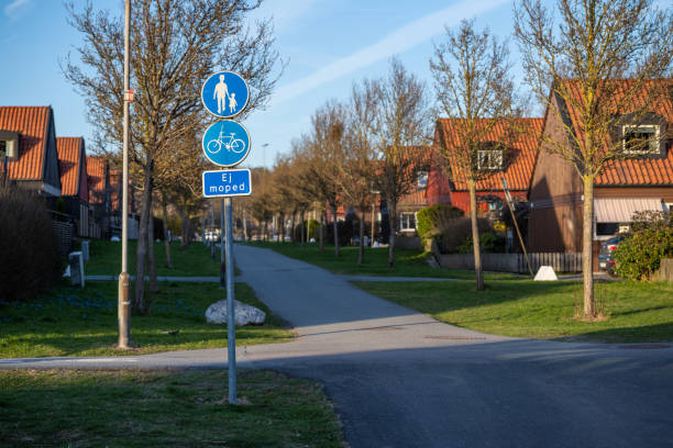 istock Walking and bike lane between identical houses.. 1556384736