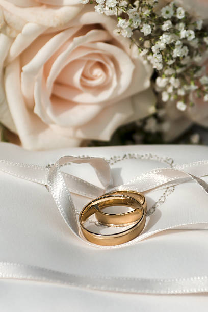 istock Gold wedding rings on brides embroidered napkin. 155640759