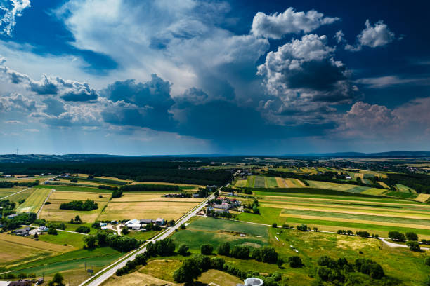 istock Thunderstorm over meadows and large cumulonimbus thundercloud and rain 1556409294