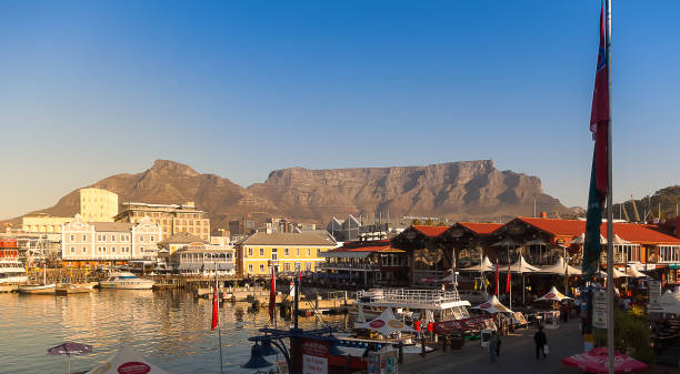 view of the victoria and alfred waterfront with table mountain in the background on a sunny day - port alfred imagens e fotografias de stock