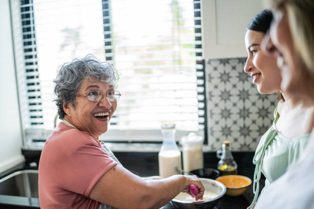 istock Three generation family talking and cooking in the kitchen at home 1556512380