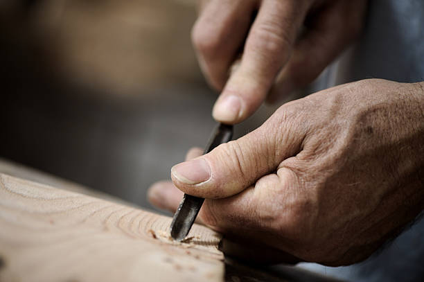istock Close-up of a craftsman's hands, working on a wood project 155652499