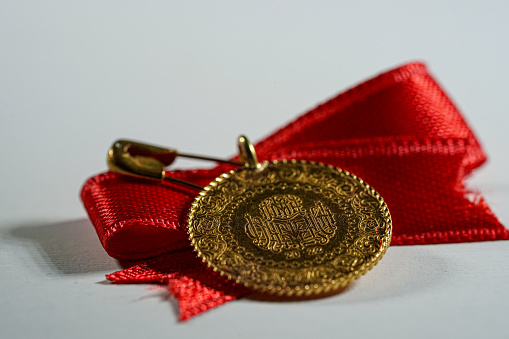 First place gold medal with ribbon isolated on white.