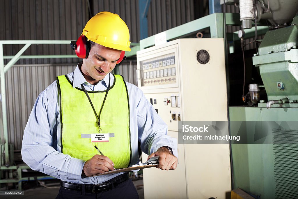 Occupational health and safety officer in factory male occupational health and safety officer inside factory doing inspection Healthcare And Medicine Stock Photo