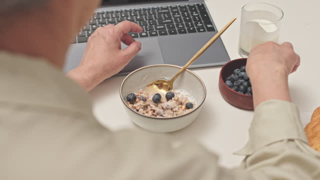 Woman Eating Healthy Granola Breakfast at Home