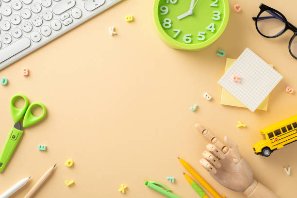 istock Step into the world of online studying from home with this captivating top-down view, presenting a keyboard, glasses and stationery on beige isolated background. Room for text or advertisements 1556568350