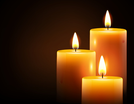 Vector illustration of three yellow candles on dark background.