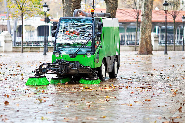 sweeping machine sweeping machine picking the leaves of the trees street sweeper stock pictures, royalty-free photos & images