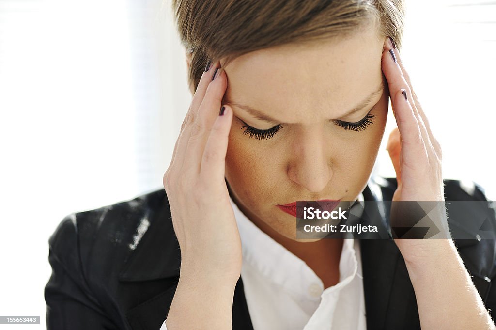 Depressed business woman Depressed business woman holding her head 20-29 Years Stock Photo