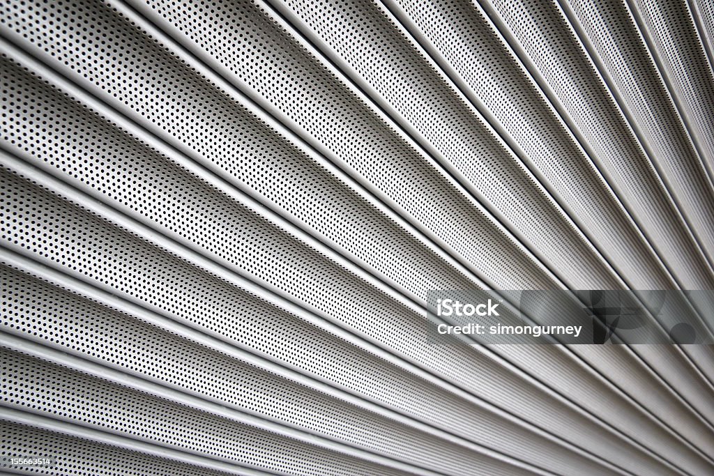 metal security shutters background abstract background of metal security shutters protecting a small shop when closed Rolling Garage Door Stock Photo