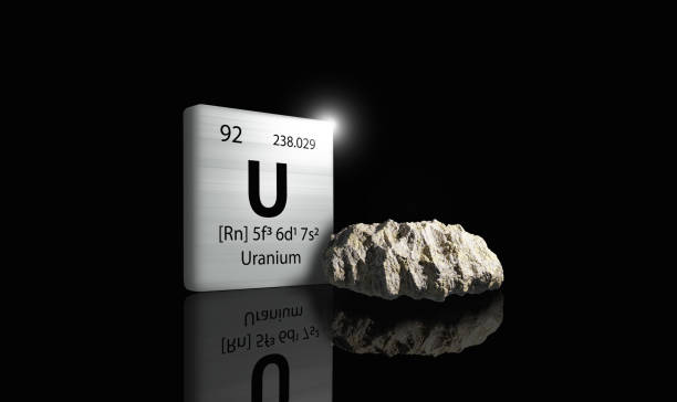 istock Uranium element on a metal periodic table with yellowish grey metamictic Uranium on dark background. 3D rendered icon and illustration. 1556635803