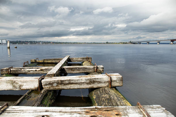 istock Old wooden bridge on the river 1556659400