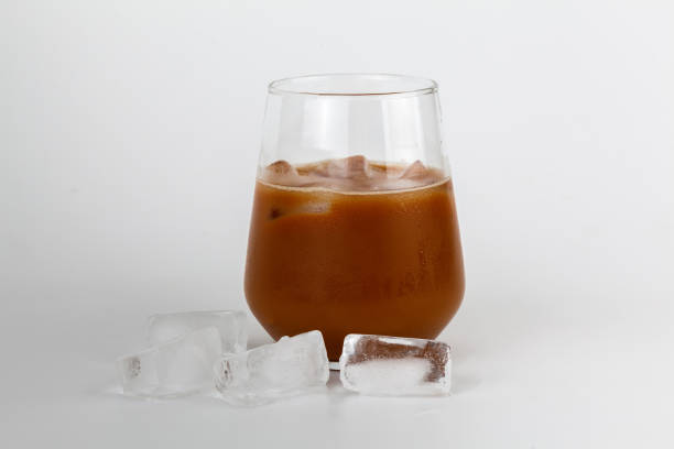 istock Iced coffee with milk and ice cubes on a white background 1556664564