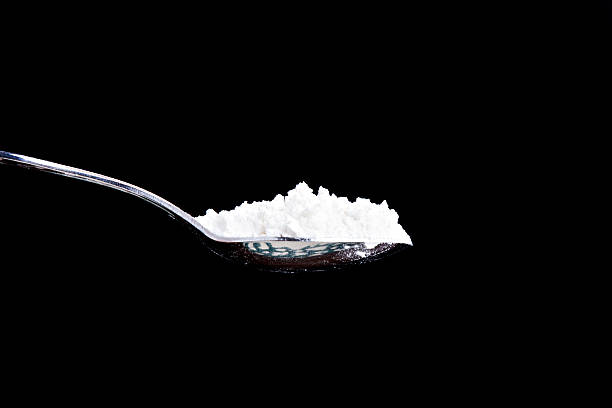 spoon full of white powder stock photo