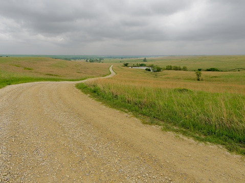 Dirt road winds through the grassland at Tallgrass Prairie Preserve Kansas.