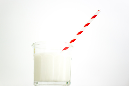Glass of Milk with Red Striped Paper Straw
