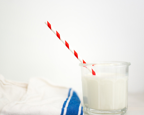 Glass of Milk with Red Striped Paper Straw