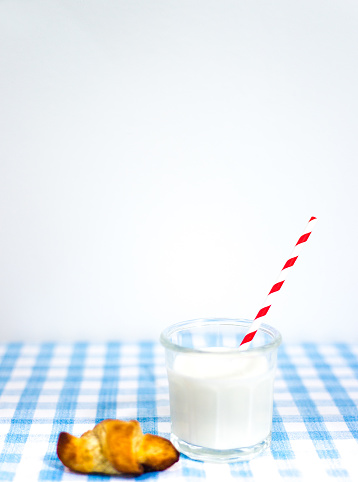 Glass of Milk with Red Striped Paper Straw, Croissant