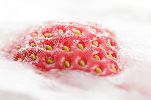 istock Strawberry partially frosen in ice 155673450