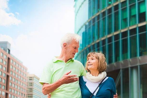 Happy senior couple walking in the city (Berlin, Germany).