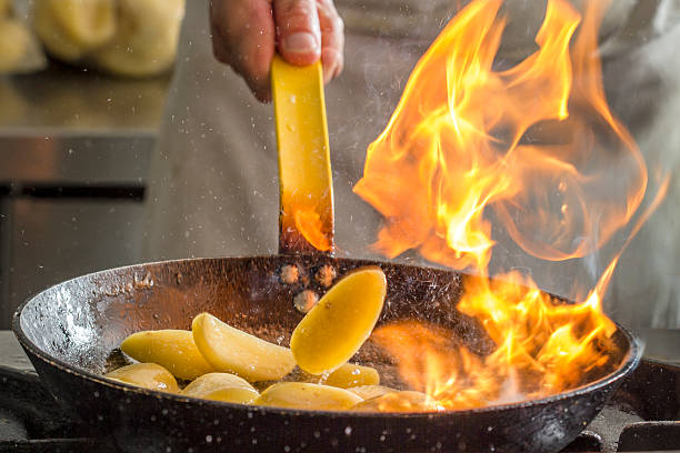 Flambing potatoes stock photo