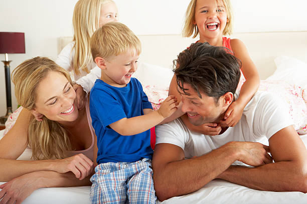 istock Happy family relaxing in bed on a weekend morning 155675563