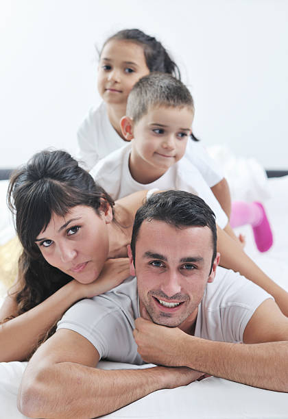 istock happy young Family in their bedroom 155677311
