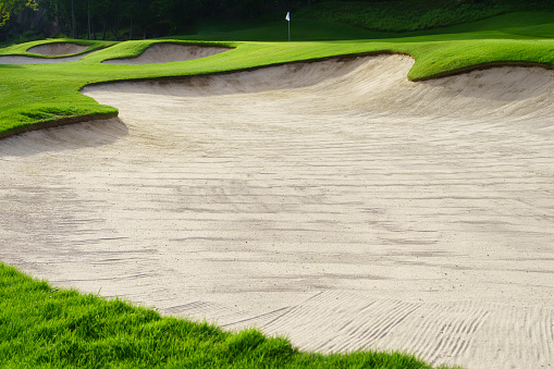 Golf Course Sand Pit Bunkers, green grass surrounding the beautiful sand holes is one of the most challenging obstacles for golfers and adds to the beauty of the golf course..