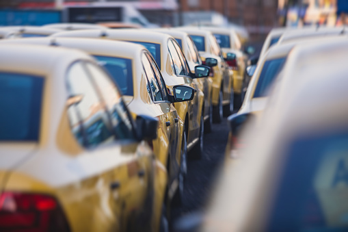 View of yellow taxi cab parking lot with yellow cars standing, set of taxicabs in the streets, taxis stand