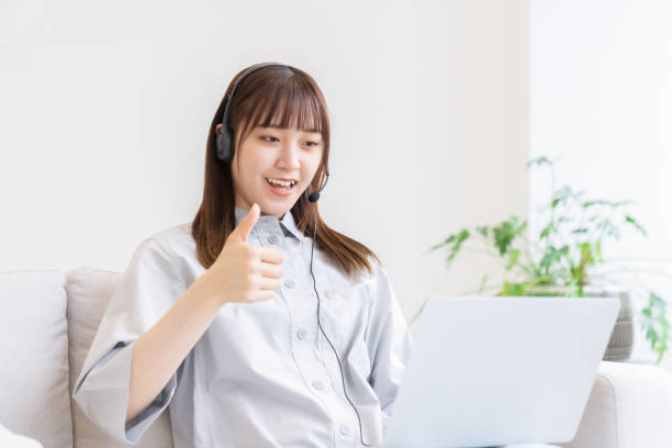 young asian woman studying with a laptop computer,correspondence course stock photo