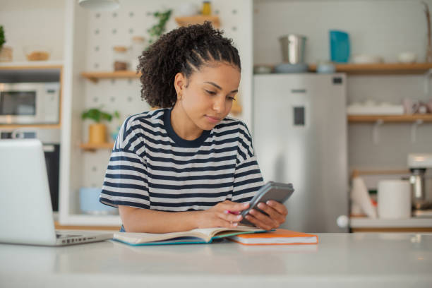 istock Young fashionable woman working at home 1556872353