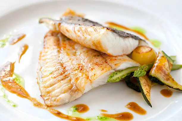 Close up of Grilled turbot fish with vegetables.