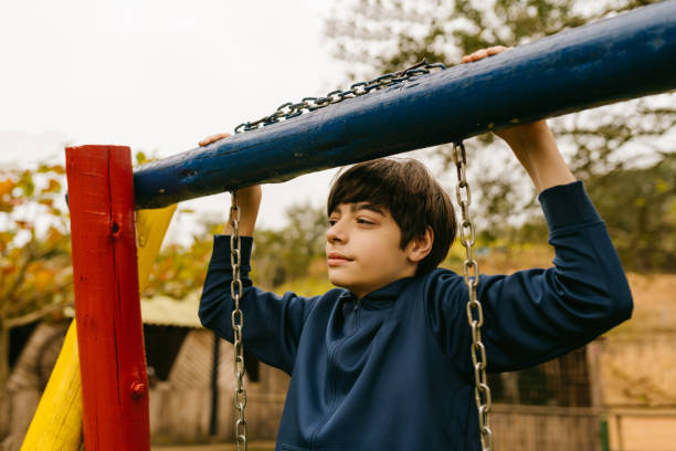 istock Contemplative pre teen boy on playground 1556905669